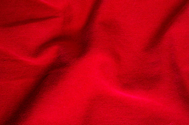 istock clothing items stonewashed red cotton fabric texture with seams, clasps, buttons and rivets, macro 1281530943