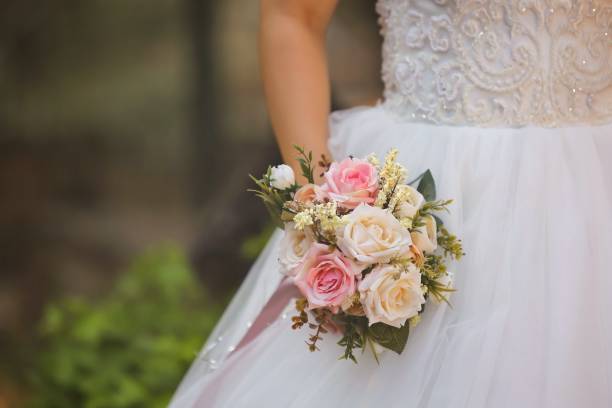 istock Bride holding a wedding bouquet in hand 1281530982