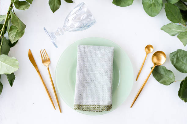 istock Natural Christmas place setting with golden silverware, eucalyptus and greens 1281531108