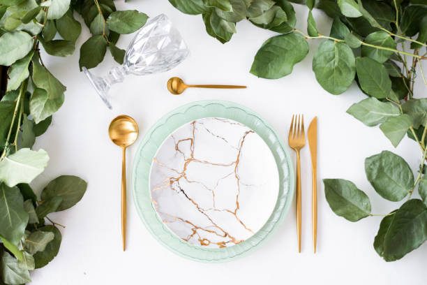 istock Natural Christmas place setting with golden silverware, eucalyptus and greens 1281531641