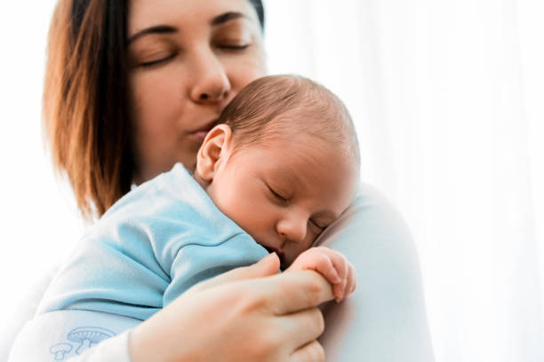 istock Mother kissing newborn son 1281531874