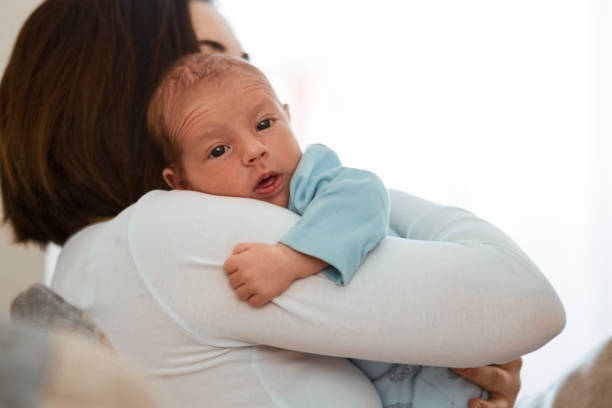 istock Mother with newborn son ,looking at camera 1281531897