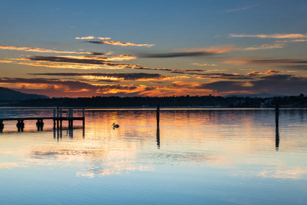 istock Clouds, reflections and sunrise over the bay 1281532064