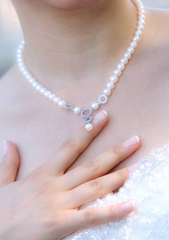 Bride Touching Pearl Necklace