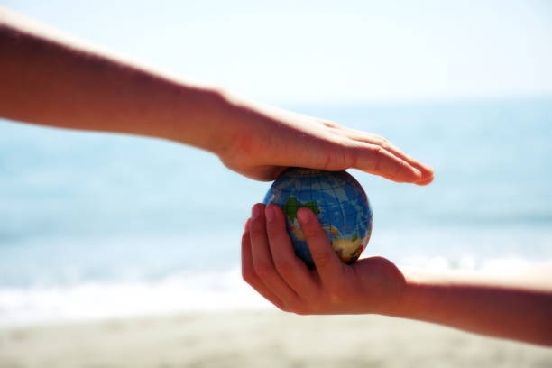 istock Personal Perspective, Children Play with Globe Ball by Sea 1281532842