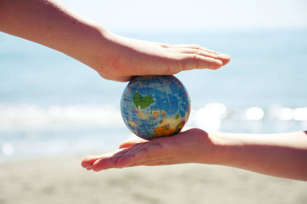 istock Personal Perspective, Children Play with Globe Ball by Sea 1281532977