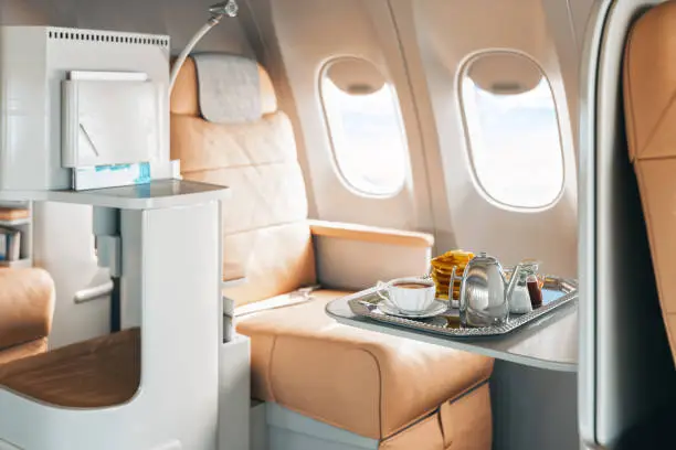 Photo of First Class Airplane Seat With Tray Of Food