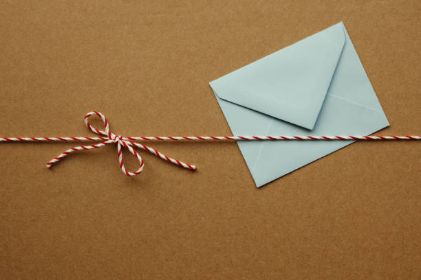 istock White Red Christmas Rope Bow and Envelope on the Package Background 1281533639