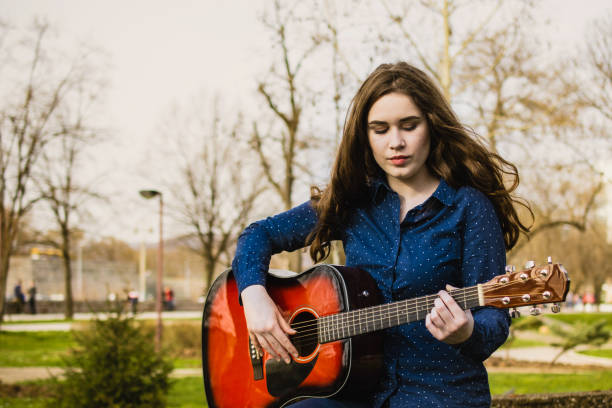 istock Young girl play guitar 1281533927