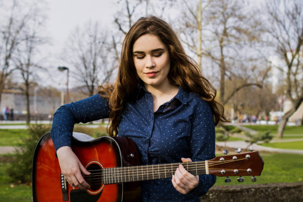 istock Young girl play guitar 1281533967