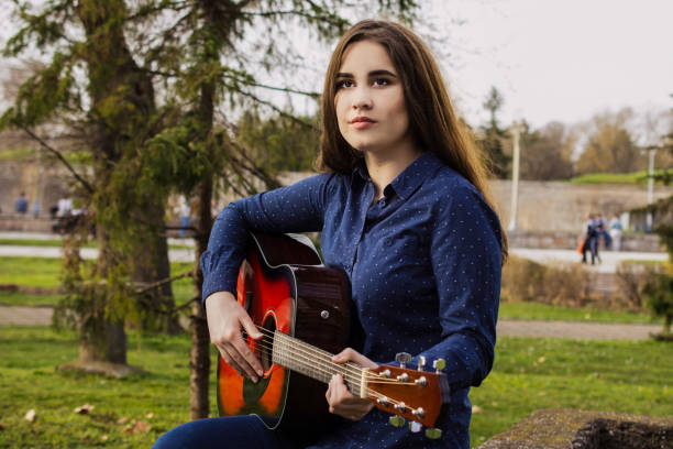 istock Young girl play guitar 1281534039