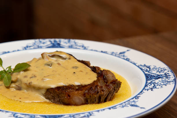 istock Entrecot with funghi sauce and creamy polenta. 1281538436