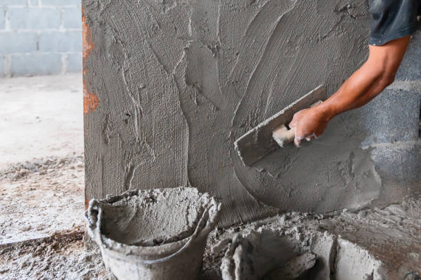 istock closeup hand of worker plastering cement at wall in construction site 1281539123