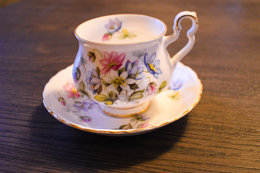 A teacup sits on a table just waiting to be used.