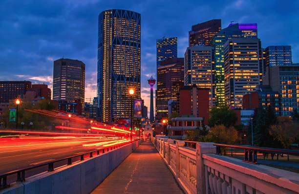 Downtown Calgary Illuminated At Dawn A view of the skyline of downtown Calgary illuminated under a sunrise sky. alberta photos stock pictures, royalty-free photos & images