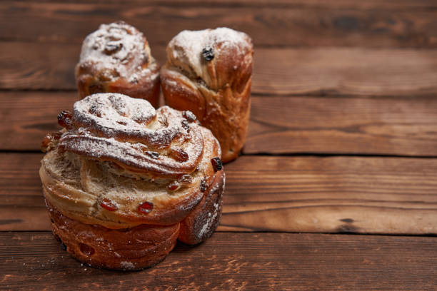 istock Traditional easter cake Kraffin stands on wooden table against a dark background. 1281542943