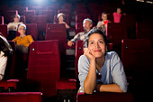 Portrait of a young woman enjoying a romantic movie at the cinema