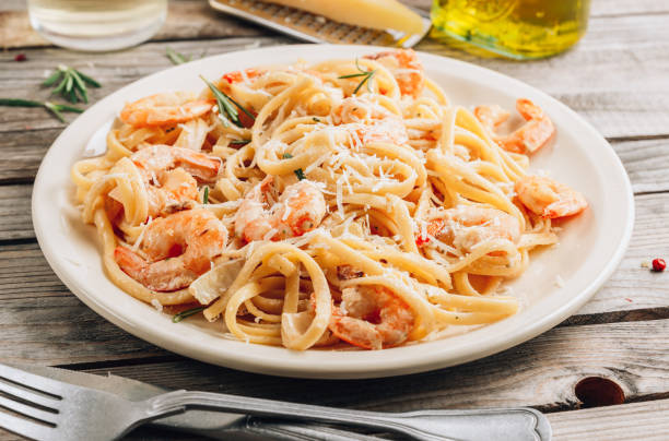 istock Pasta tagliatelle with shrimps in creamy sauce 1281549147