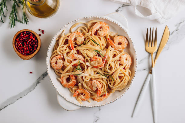 istock Pasta tagliatelle with shrimps in creamy sauce 1281549151