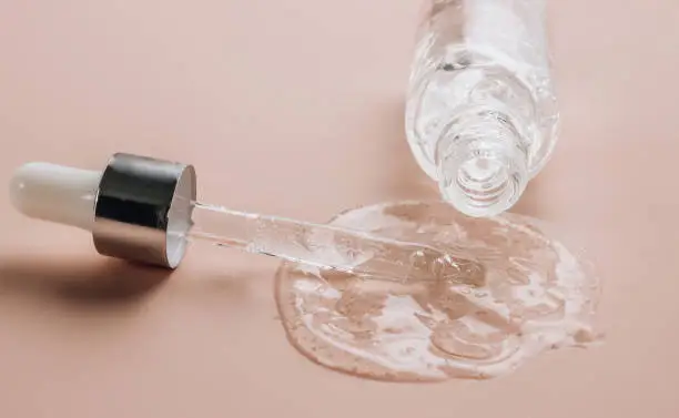 Photo of Hyaluronic acid on skin color background with oxygen bubbles.