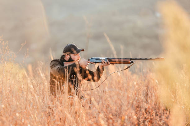istock A hunter with a gun. Autumn hunting. Huntsman. 1281552650