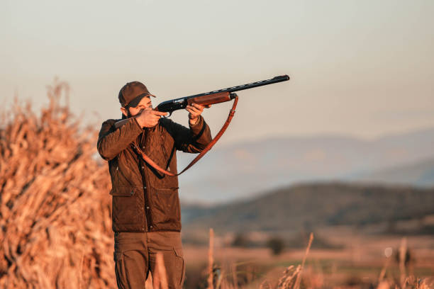 istock A hunter with a gun. Autumn hunting. Huntsman. 1281552661