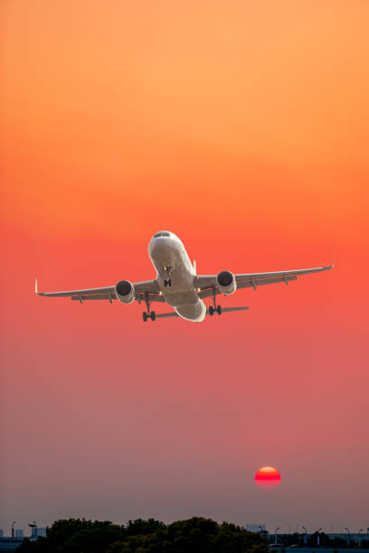 istock Commercial airplane flying above clouds in colorful sunset. 1281553683