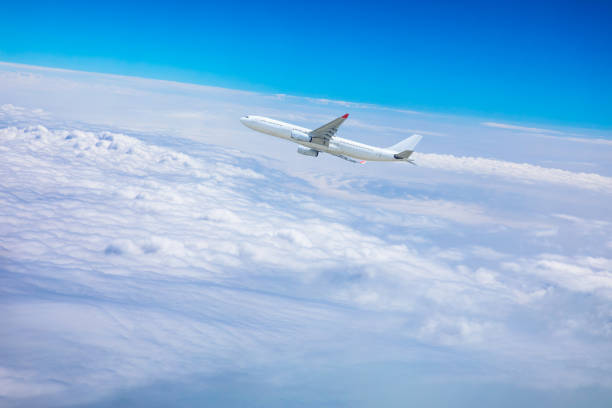istock Commercial airplane flying above blue sky and white clouds. 1281553777