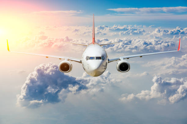 istock Commercial airplane flying above clouds in colorful sunset. 1281553837