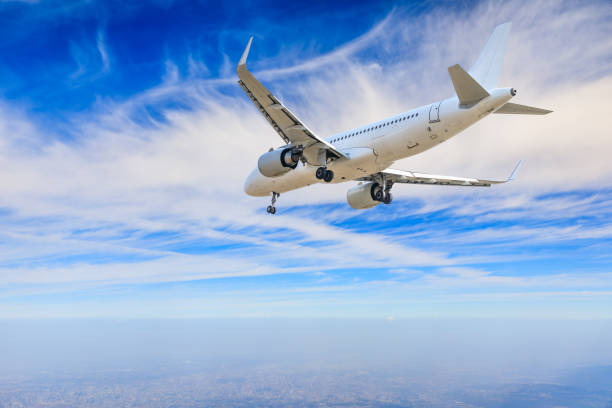 istock Commercial airplane flying above blue sky and white clouds. 1281553848