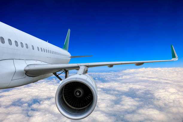 istock Commercial airplane flying above blue sky and white clouds. 1281554018