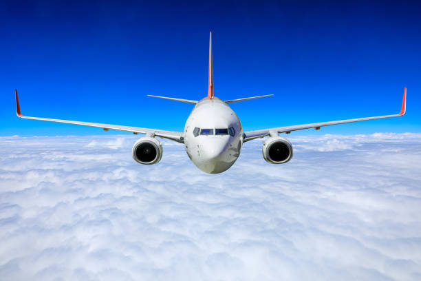 istock Commercial airplane flying above blue sky and white clouds. 1281554022