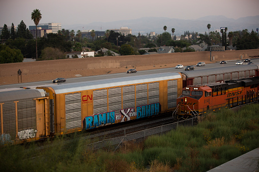 San Bernardino, California/USA - October 3, 2020: The 215 Freeway and a freight train pass through downtown San Bernardino.