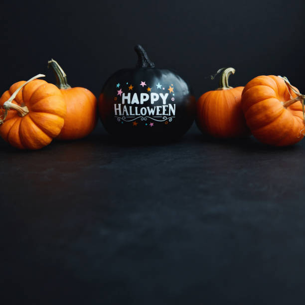 Halloween Background with Black and Orange Pumpkins and Happy Halloween Message