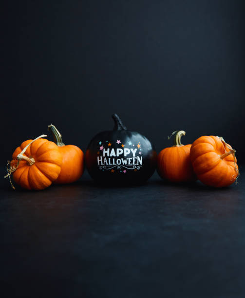 istock Halloween Background with Black and Orange Pumpkins and Happy Halloween Message 1281554817