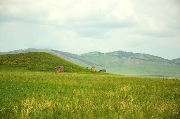 istock Ancient earthen mounds with menhirs around standing in a picturesque steppe. 1281556470