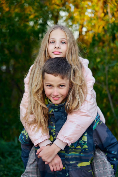 istock Boy posing with a girl on his back 1281561079