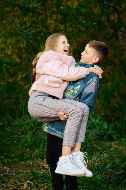 istock Boy holding a girl in his arms 1281561081
