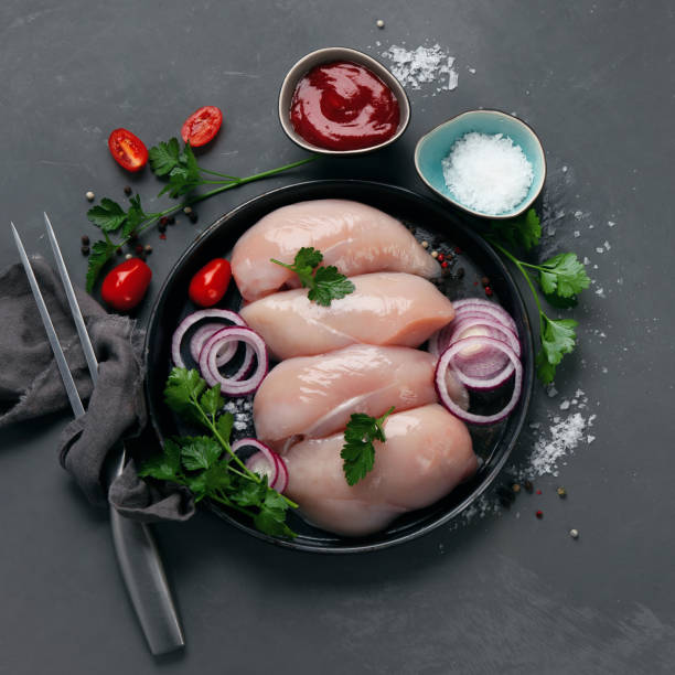 istock Fresh raw chicken fillet with spices 1281563890