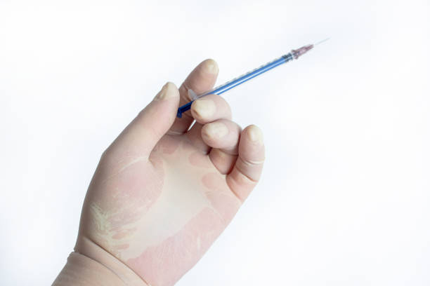 istock The hand holding the syringe.Isolated on a white background. 1281564057