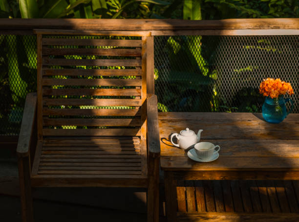 istock Relaxing corner with beautiful white coffee mugs on a wooden table in a natural setting in the morning. 1281566062