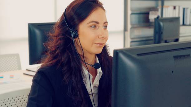 istock Business people wearing headset working in office 1281566909