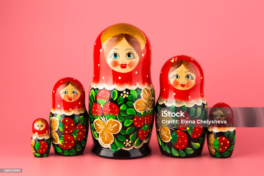 Set of wooden toys matryoshka on a pink background Russian Nesting Doll Stock Photo
