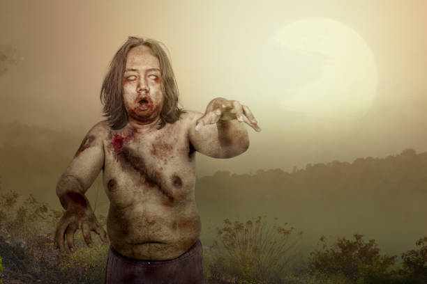 istock Scary zombie with blood and wound on his body walking 1281573981