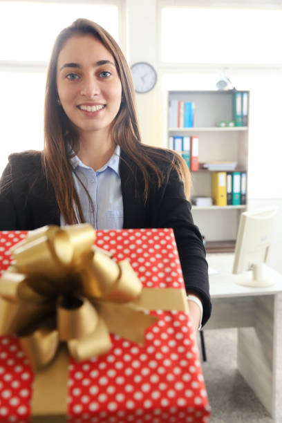 istock Young businesswoman holding a gift 1281574335