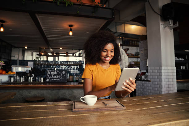 istock Happy customer choosing meals from menu while enjoying coffee in trendy cafe 1281574352