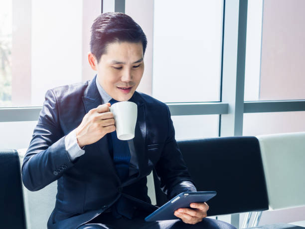 istock Asian businessman in suit wearing protective face mask. 1281577184