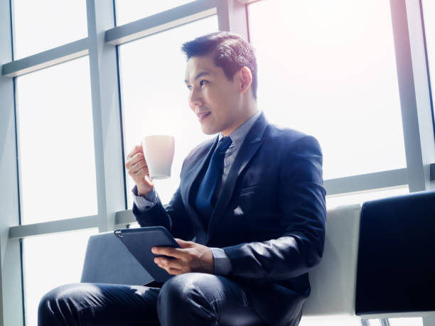 istock Asian businessman in suit wearing protective face mask. 1281577197