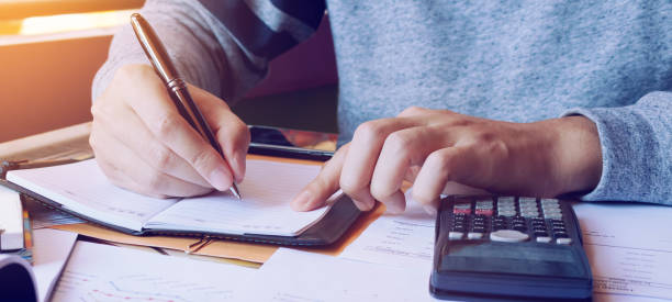 istock Young man doing finance in home office with calculate about cost. 1281577251