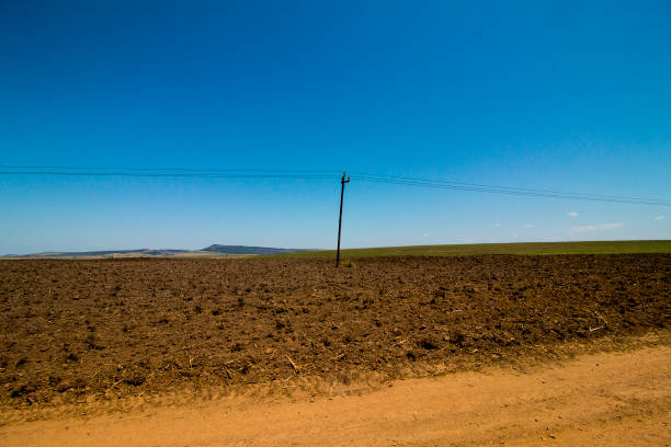 istock Electricity Pole and Cables in a Freshly Ploughed Field 1281577490